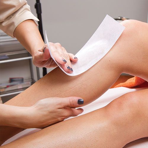 Leg waxing treatment with wax strip
